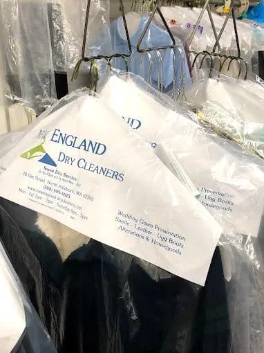 Dry-cleaned garments bagged, tagged, and ready for collection at New England Dry Cleaners